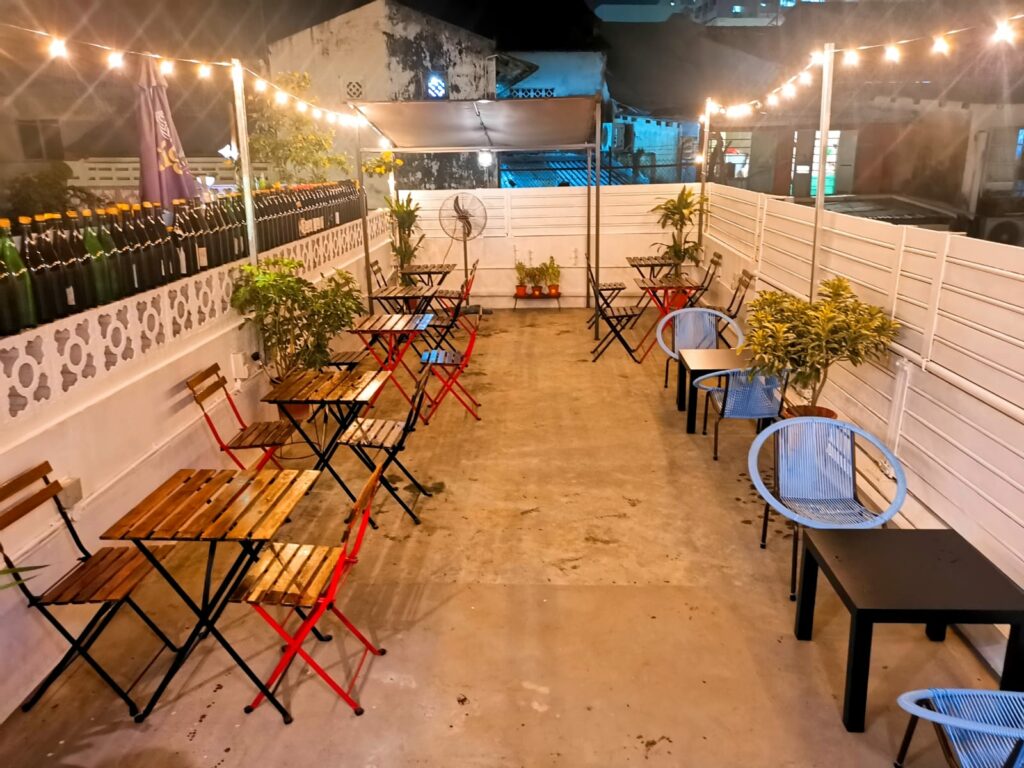 best affordable rooftop bar - Olibier Rooftop Bar - small rooftop outdoor seating area with hanging lights