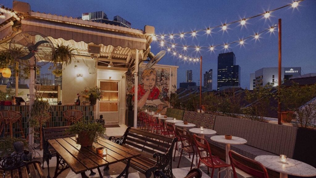 best affordable rooftop bar - potato head - outdoor rooftop patio seating with hanging lights