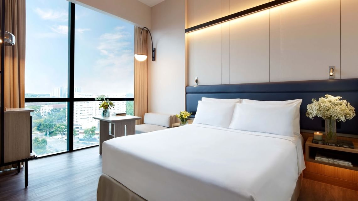 Comfortable hotel bed for a cheap staycation.